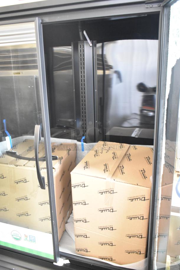 Brand new True TVM-48SL-HC commercial cooler with two doors. Visible packaging and minor exterior scratches. 115V, 1 phase.