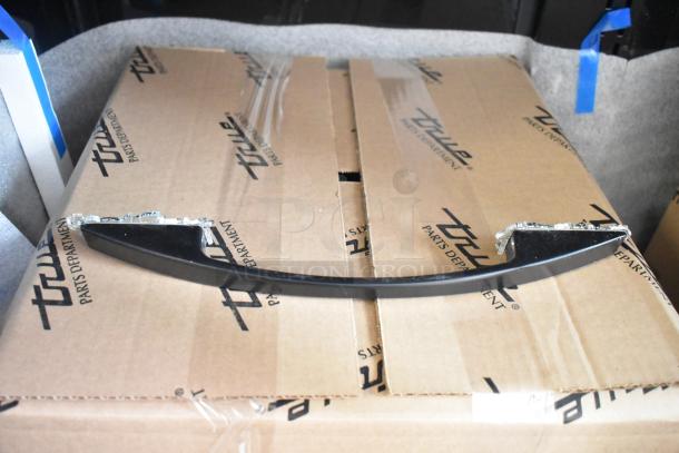 Brand new 2025 True TVM-48SL-HC commercial cooler in packaging. Cardboard box marked "True Parts Department."