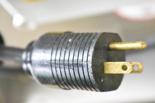 Close-up of a heavy-duty, three-prong electrical plug on the JBT 2nd-Gen MFJ-HE commercial citrus juicer.