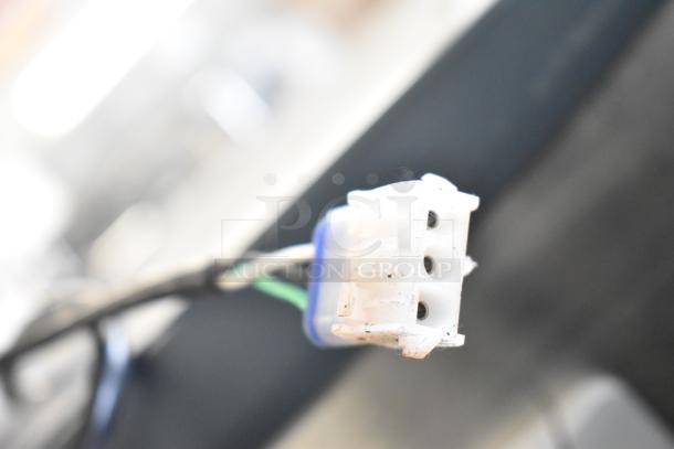Close-up image of a connector plug from the 2022 Scotsman NH0622A-1B Ice Head. Wires visible, showing part of the machinery.