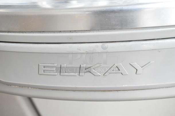 Brand new Elkay wall mount water fountain, scratch and dent, 115 volts, 1 phase, embossed Elkay logo visible.