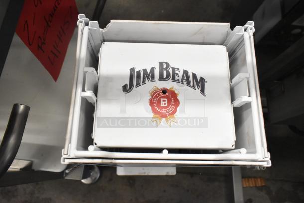 Jim Beam sign in a white frame, featuring logo and red emblem. In used condition with visible wear.