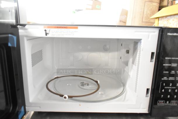 Hamilton Beach HB8436127995-02 countertop microwave oven with glass plate, 120 volts, 1 phase. Interior view, showing clean condition.