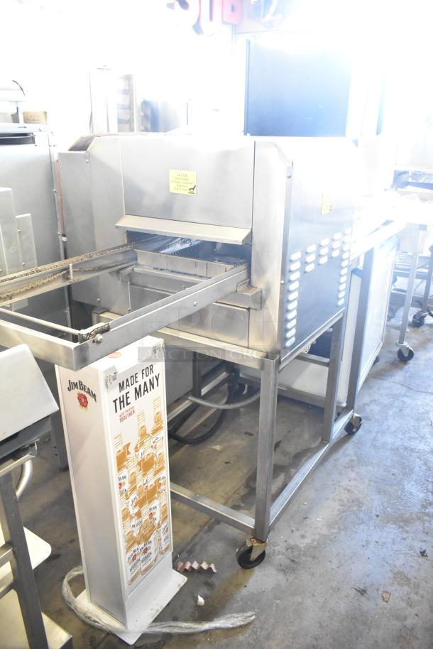 Belshaw Adamatic TG-50 stainless steel thermoglazing station on casters, 208V, 1 phase. Signs of use, commercial kitchen setting.