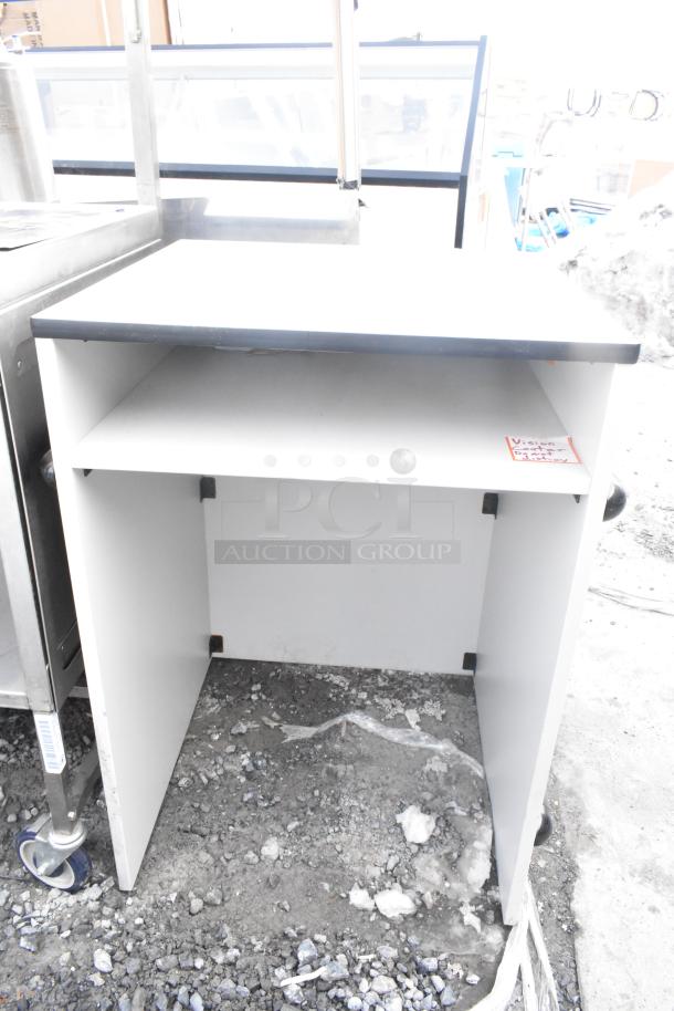 White counter with dark trim, open shelf, visible markings indicate "Vision Center". Appears in used condition.