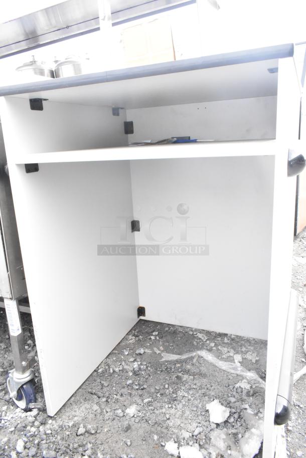 White kitchen counter with two shelves, visible wear and dirt on bottom shelf. Features metal corner brackets for support.