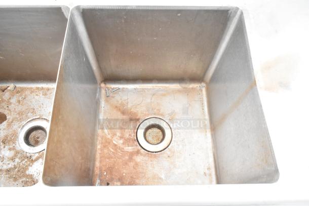 Commercial 3 bay sink with right side drain board, stainless steel, signs of use, functional drain in each compartment.