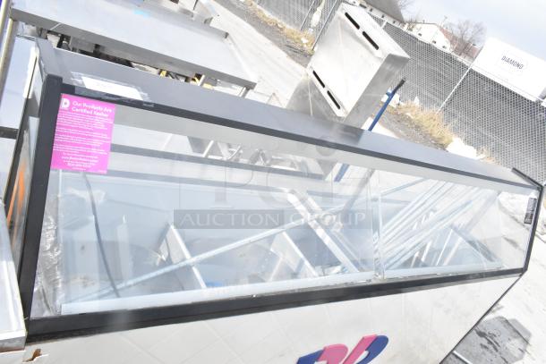 Commercial ice cream dipping cabinet with metal tub collars and glass display. Includes Baskin Robbins branding and Kosher certification label.