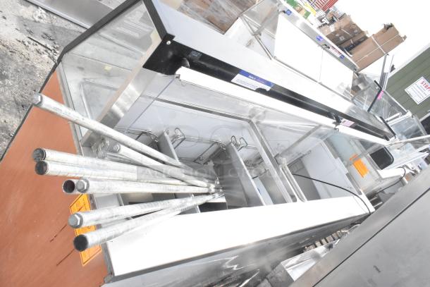 Commercial ice cream dipping cabinet with metal tub collars, stainless steel finish, glass top, showing pristine condition.