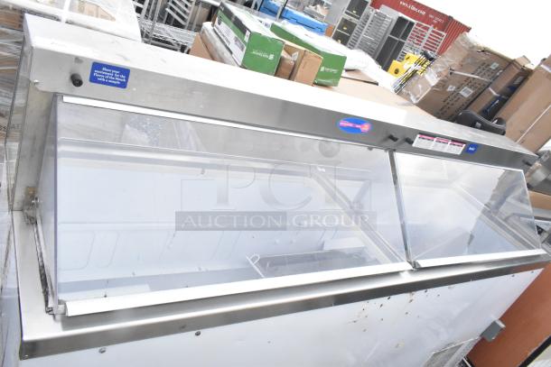 Commercial ice cream dipping cabinet with stainless steel frame, glass display, and visible control panel. Condition appears used.