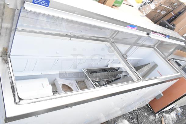 Commercial ice cream dipping cabinet, stainless steel, glass top, fair condition, interior shows cooling system components.