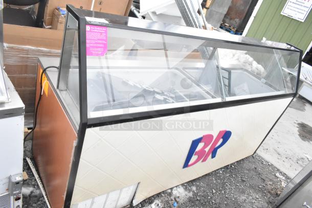 Commercial ice cream dipping cabinet with glass display, slight wear visible, kosher certification tag on the glass.