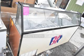 Commercial ice cream dipping cabinet with glass display, slight wear visible, kosher certification tag on the glass.