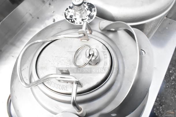 Two metal 3-gallon kegs, A.E.B. Italy, max working pressure 130 PSI, secure latches, clean condition.