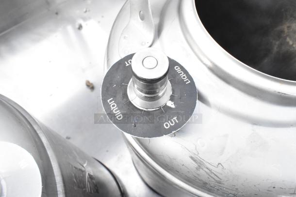 Two metal 3-gallon kegs with liquid in/out valve, showing minor surface wear. Auction includes double the bid.