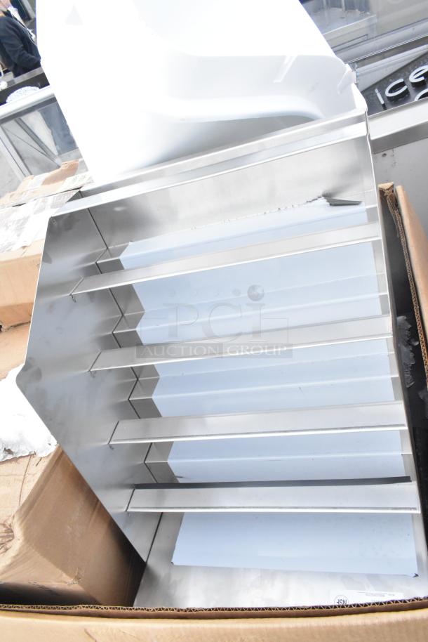 9 brand new items, including Cambro front load catering case, bun warmer, trays, and ingredient bin, in box.