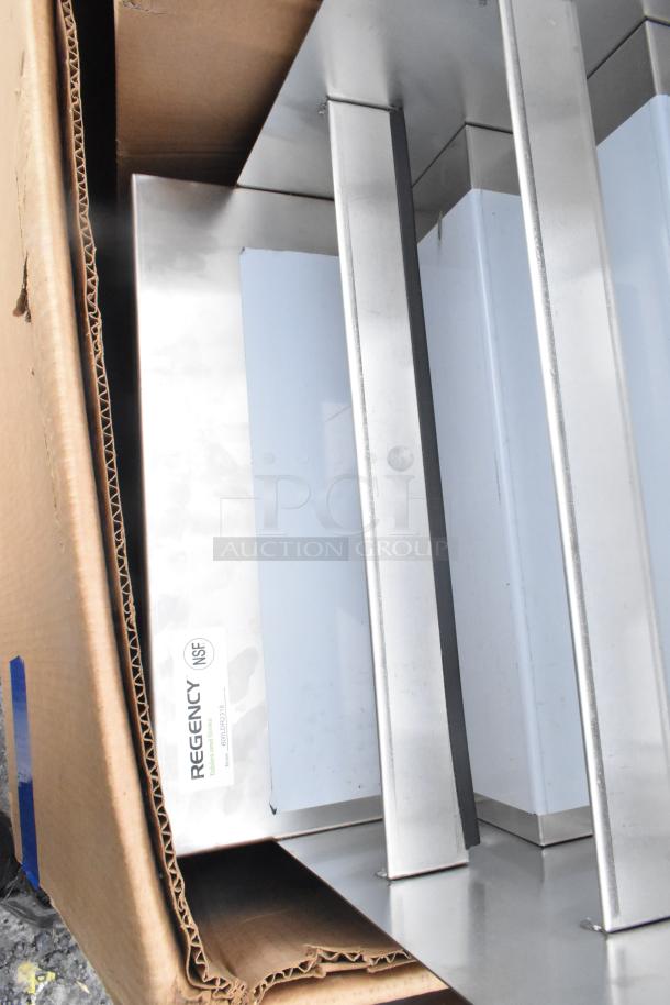 Nine brand new scratch and dent items, including Cambro catering case, visible Regency NSF label, in cardboard packaging.