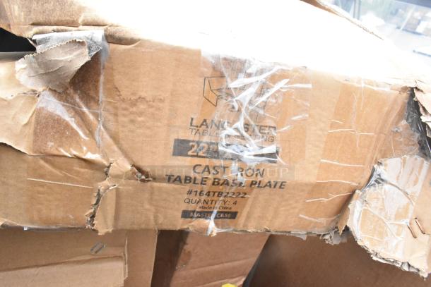 Damaged box labeled "Lancaster Table Seating," 4 cast iron table base plates. Scratch and dent condition.