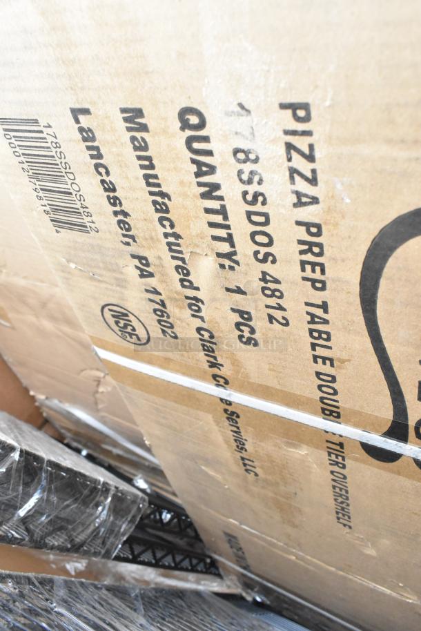 Cardboard box labeled "Pizza Prep Table Doub S/DOS 4812," with visible wear. Contains brand new scratch and dent items.