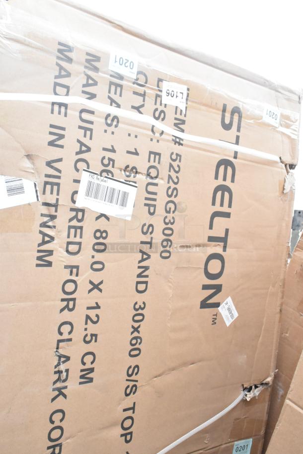 Cardboard box labeled "Steelton," containing scratch and dent items. Visible details: item #522SG3060, size 30x60, made in Vietnam.