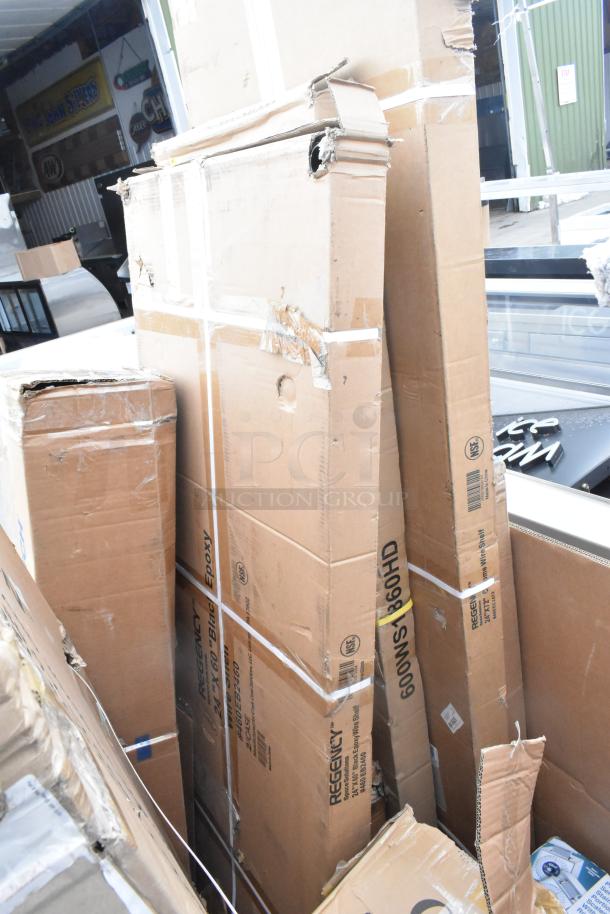 Damaged boxes containing scratch and dent items, including an evaporator coil and shelves; Regency Black Epoxy label visible.