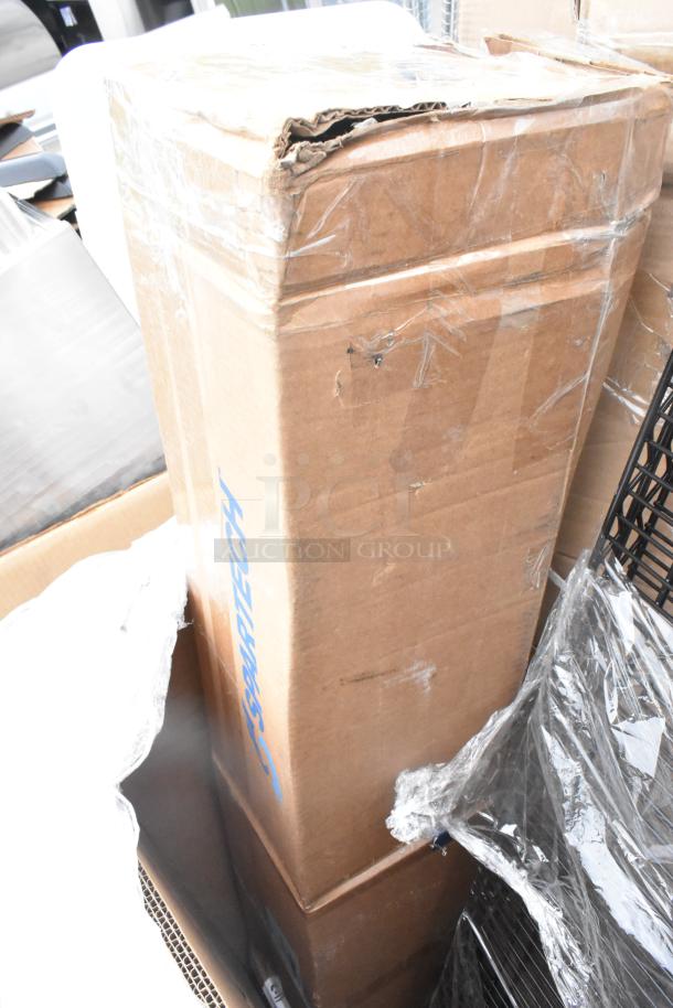Cardboard box of auction items, labeled "Scratch and Dent," wrapped in plastic. Contains evaporator coil, scale, shelves.