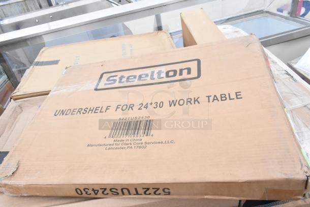 Cardboard box labeled "Steelton Undershelf for 24x30 Work Table." Box slightly dented, barcode visible. Brand new condition.