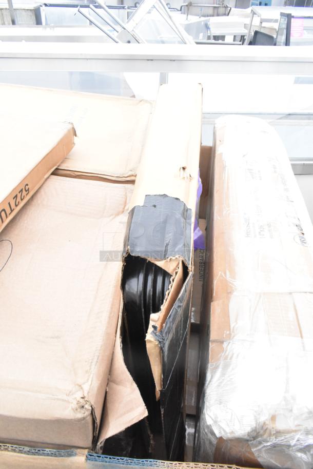 Stack of boxed items including trays and bussing carts in good condition with some packaging wear. Labels indicate "5321TU."