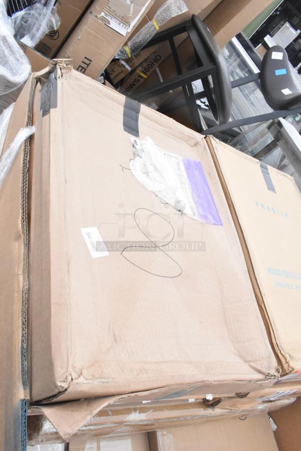 Cardboard boxes with visible wear, labeled "Fragile," containing brand new scratch and dent items, such as trays and bussing carts.