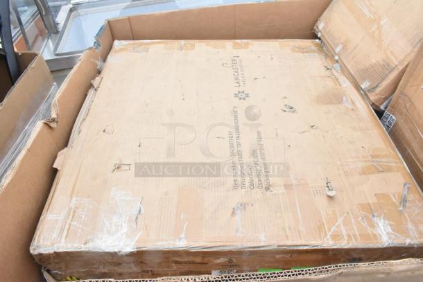 10 new scratch and dent items including trays and bussing carts in cardboard packaging. Lancaster Table & Seating label visible.
