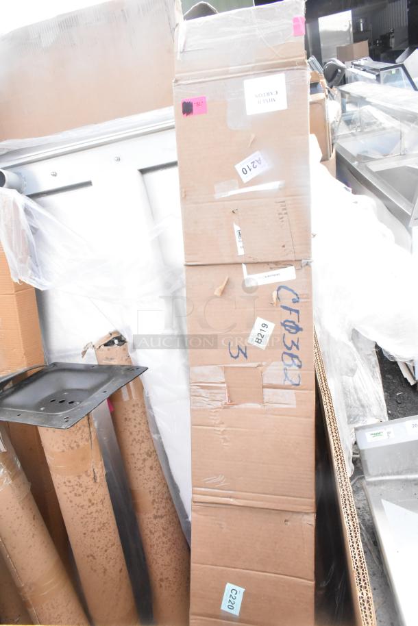 Boxes of 17 scratch and dent items, including a table and platform truck, marked with labels like "A210" and "B219."