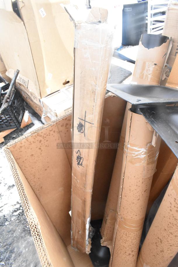 Cardboard boxes with scratch and dent label; items include a table and platform truck. New condition with visible packaging.