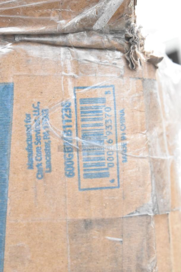 Close-up of a cardboard box label indicating manufacture for Clark Cinc Services, LLC, with barcode and "Made in China."