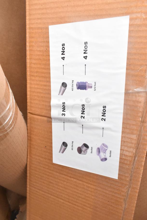 Cardboard box labeled with components: 4x 40 Dia legs, 4x SS feet, 3x 30 Dia legs, 2x sockets. New scratch and dent condition.