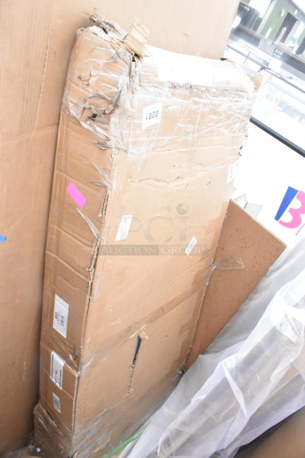 Cardboard box containing a brand new scratch and dent item, visible wear on packaging; markings include "0201."