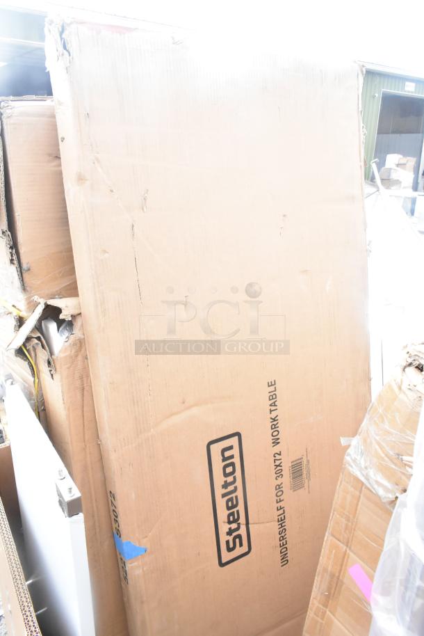 Cardboard box labeled "Steelton" for 30x72 work table, part of a lot with 17 scratch and dent items, including platform truck.