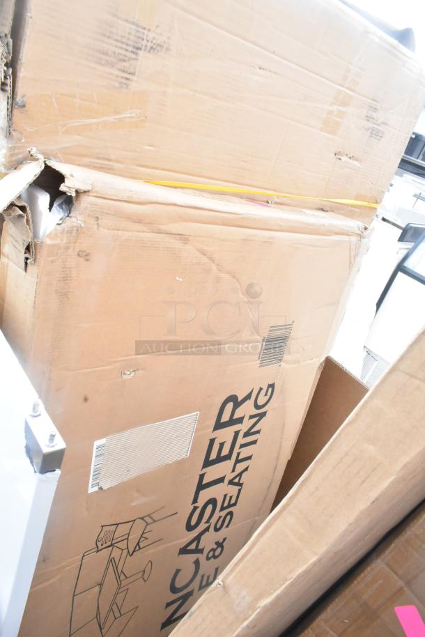 Cardboard boxes of brand new "Lancaster Table & Seating" items, slight scratches and dents visible. Auction lot of 17.