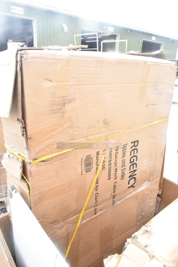 Cardboard box labeled "Regency" containing a 16 gauge work table, model 600TSB3060S. Box shows signs of wear.
