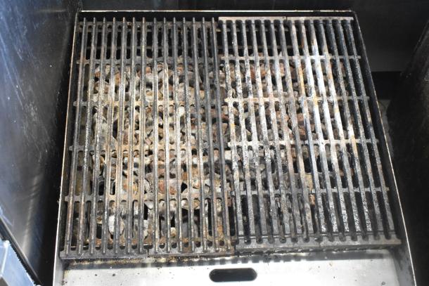 Star Max commercial countertop gas charbroiler grill with metal grates, used, visible wear and residue.