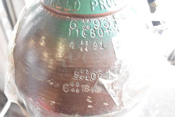 Metal tank with embossed text, indicating manufacturing details; visible wear and transparent tape in some areas. Pickup only.