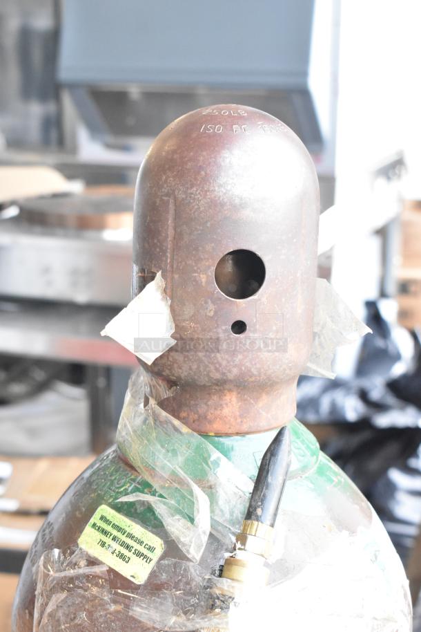 Rusty metal tank with labeling indicating 250 LB pressure, wrapped in plastic. Pickup required, not shippable.