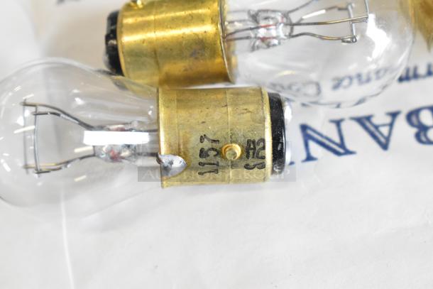 Lot of various items including light bulbs. Features bulbs with brass bases, visible markings "1157" and "A23."