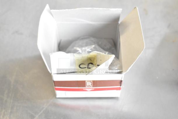 Open white box containing various items, possibly light bulbs. Box has torn flaps and a label marked "CDX".