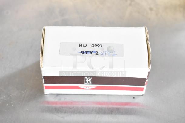 Box labeled "RD 4997" with crossed out "QTY 2" and written "QTY 1"; appears part of a lot including light bulbs.