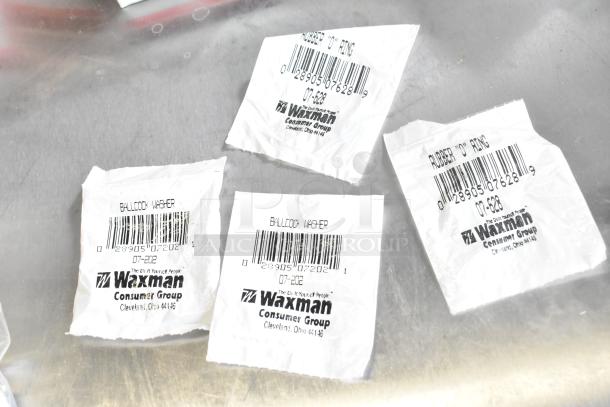 Lot of Waxman items including ballcock washers and rubber O-rings, barcodes visible, in plastic packaging, new condition.