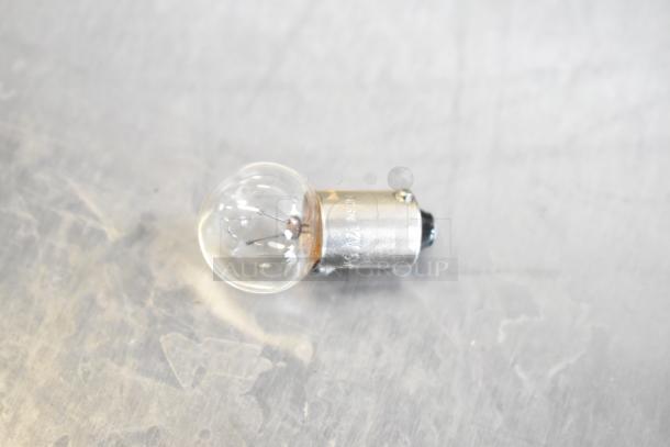 Clear light bulb with metal base, part of an auction lot of various items. Base marked "12V SWF."