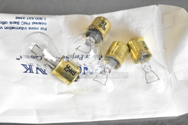 Lot of various light bulbs with brass bases. Some bulbs marked "GE 55." Items in good condition on labeled envelope.