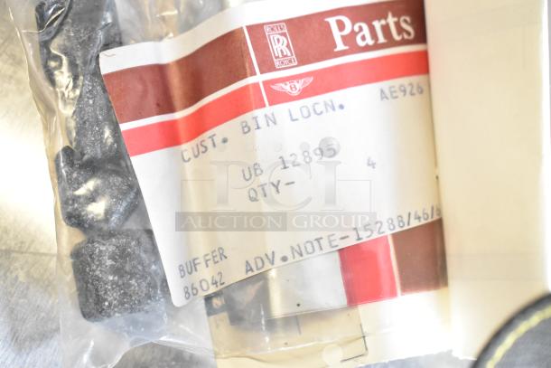 Lot of various items with a Rolls Royce parts label. Includes buffers and other components in sealed packaging.