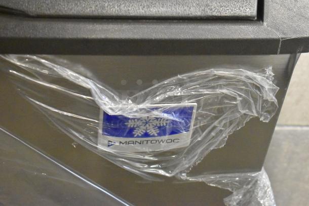 Brand new Manitowoc UDF0310A-261Z undercounter dishwasher, 2022 model, scratch and dent, wrapped with visible logo.