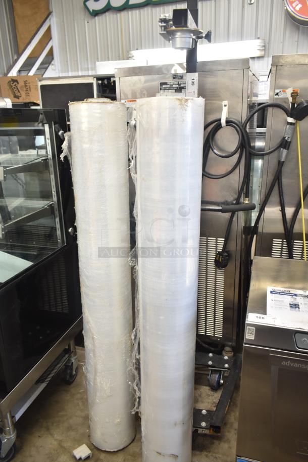 Fantom Full Web Portable Shrink Wrapping Station with two large rolls of shrink wrap. Some wear visible on the rolls.